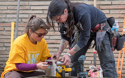 Two women working on a project together.